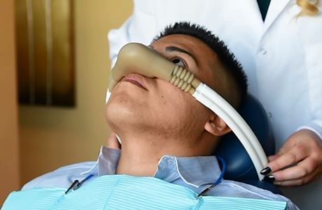 photo of dentist placing nitrous oxide delivery on patient prior to treatment